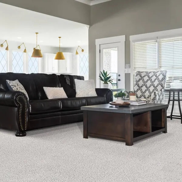 Laminate flooring in a large living room with stairs incorporated by FloorCo Premium Temple, Waco, and Killeen, Texas.