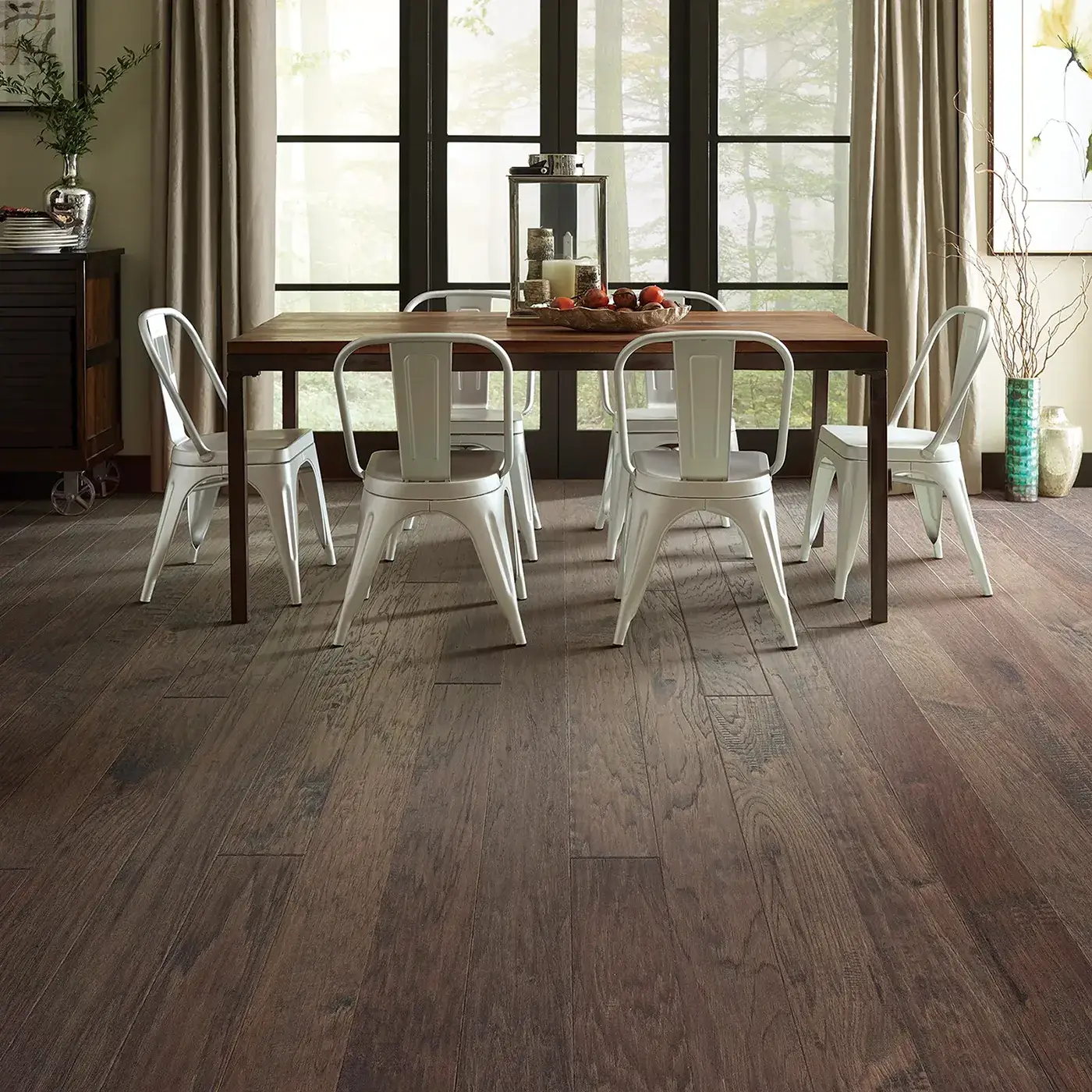 Gray-brown hardwood in a dining room with a dark wood table | FloorCo.