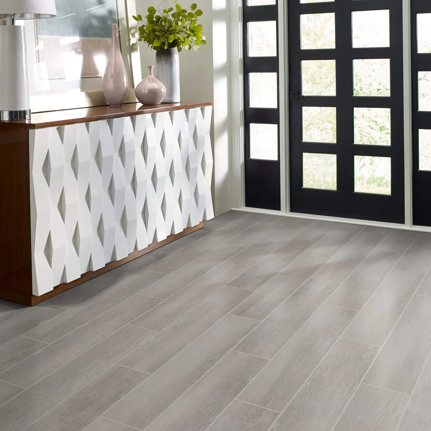 Tile with a light gray wood look, in an entryway | FloorCo.