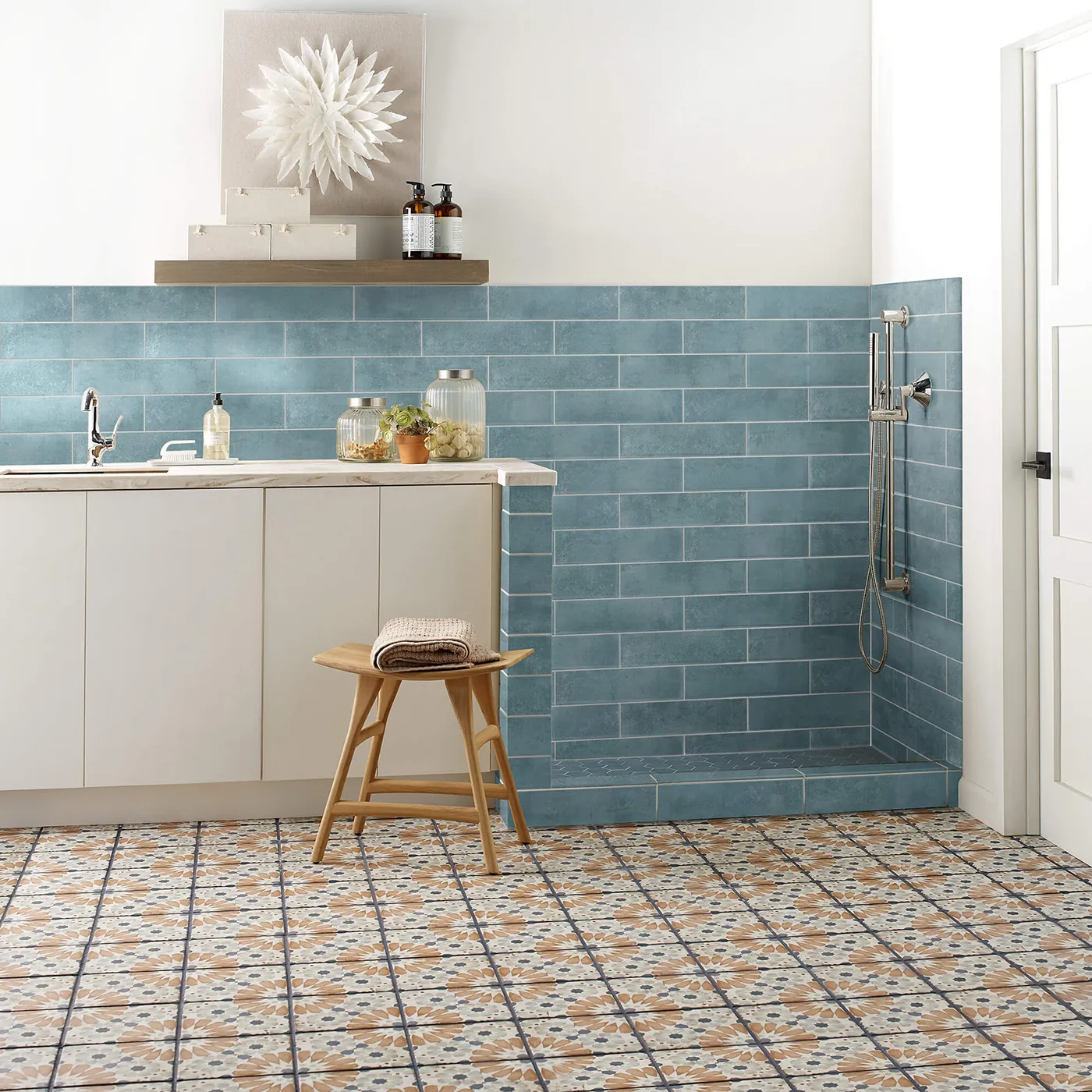 Mint blue subway tile on the wall and multi-colored patterned tile on the floor | FloorCo.