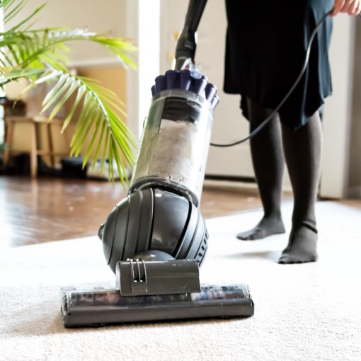 Person vacuuming carpet | Floorco Premium