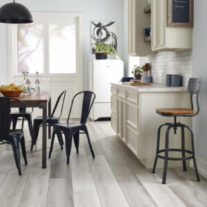 Grey wood-look vinyl flooring in kitchen | Floorco Premium