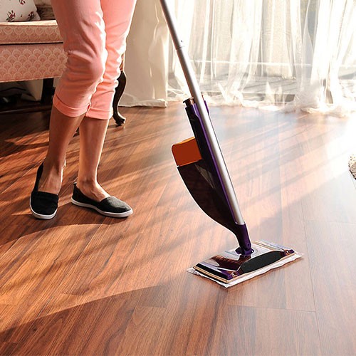 Person cleaning laminate flooring | Floorco Premium
