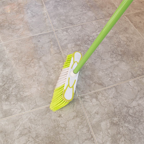 Broom sweeping tile flooring | Floorco Premium