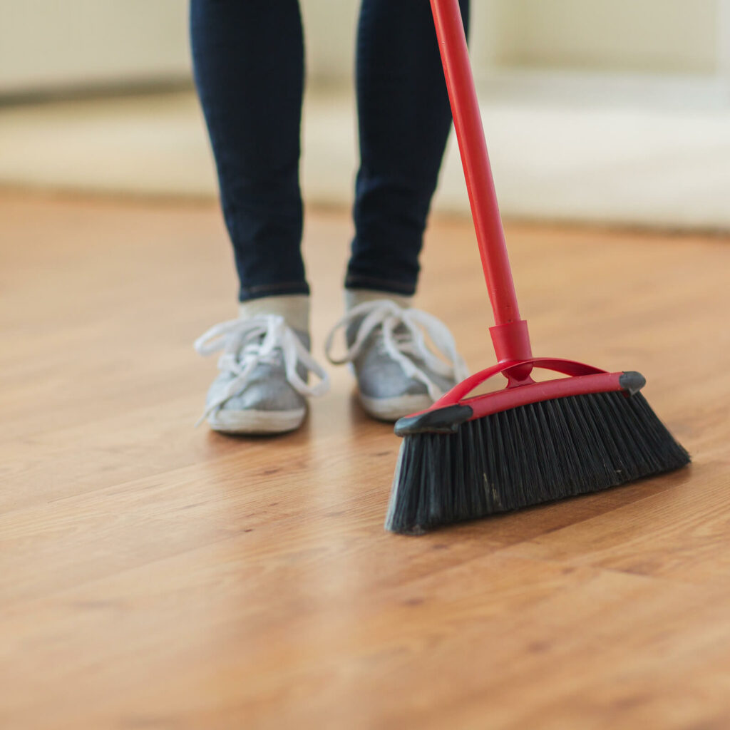 Person sweeping laminate flooring | Floorco Premium